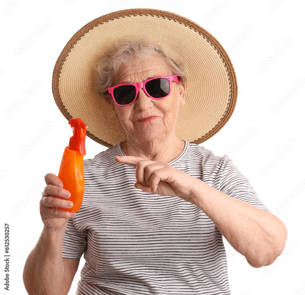 Senior woman pointing at sunscreen cream on white background