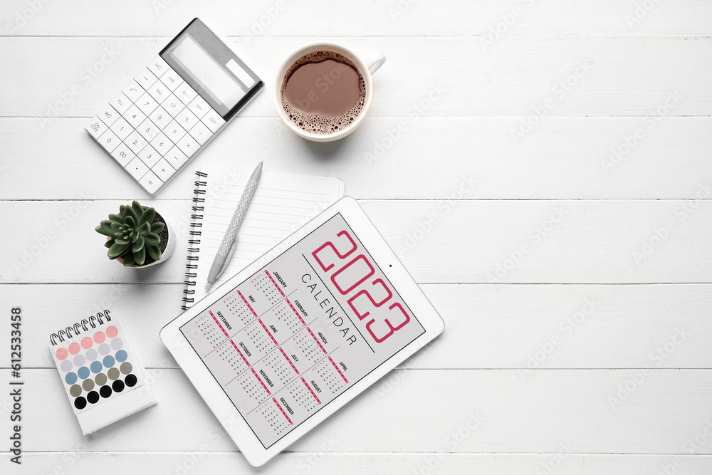 Composition with calendar, cup of coffee and calculator on white wooden background