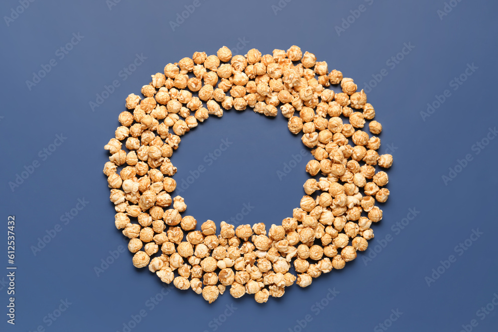 Frame made of crispy popcorn on blue background