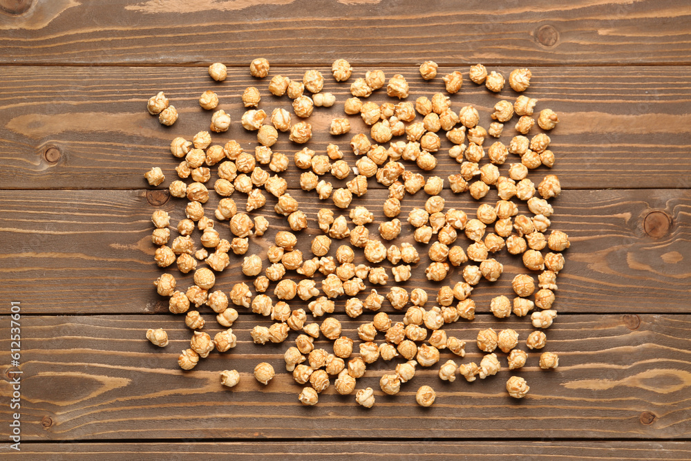 Crispy popcorn on wooden background