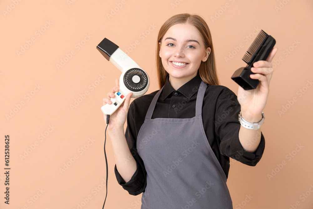 Female hairdresser with dryer on beige background