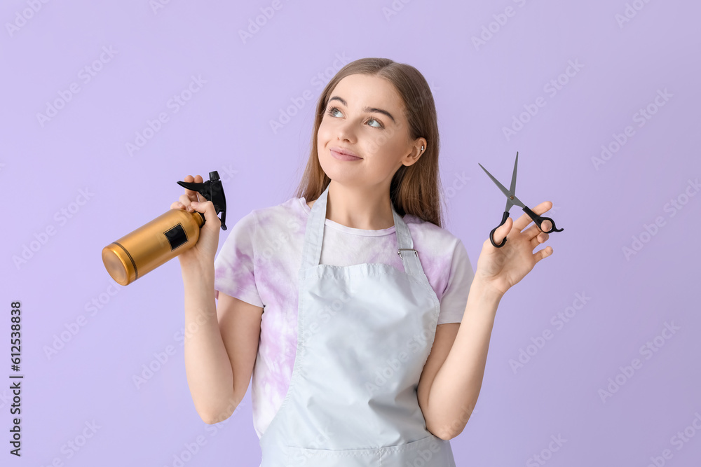 Female hairdresser with scissors and spray on lilac background