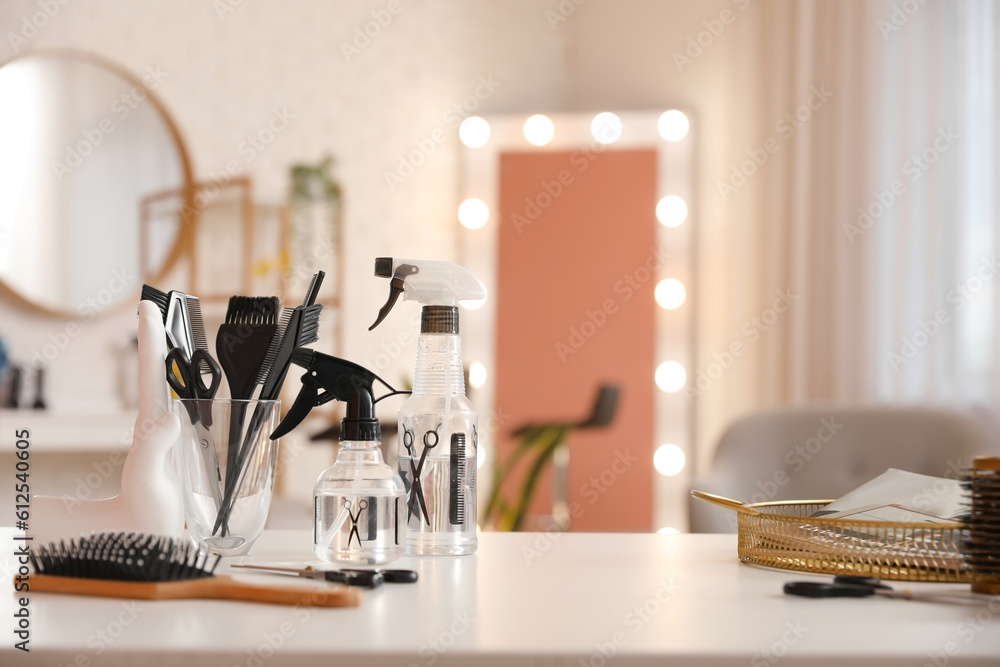 Different hairdressing tools on table in beauty salon