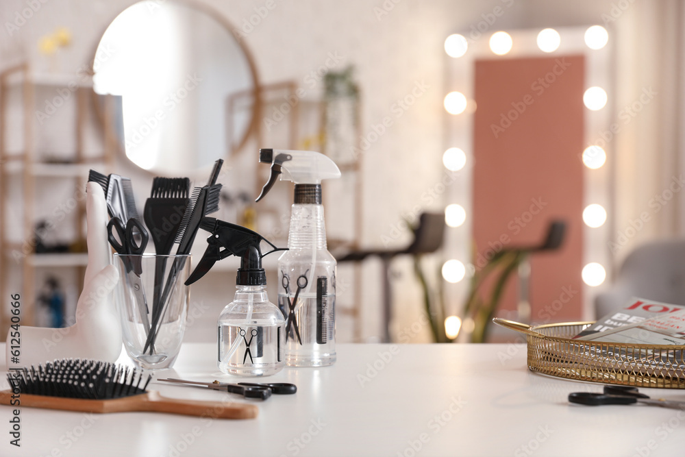 Different hairdressing tools on table in beauty salon