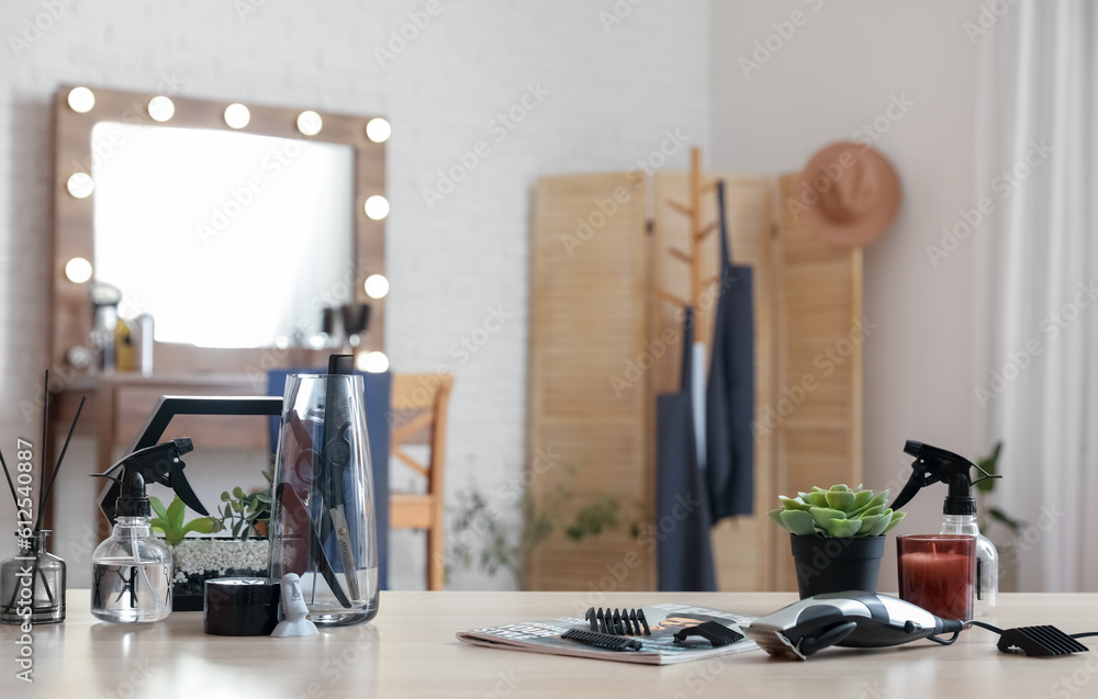 Different hairdressing tools on table in beauty salon