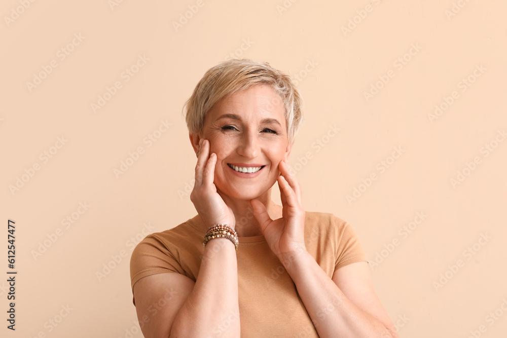 Mature blonde woman on beige background