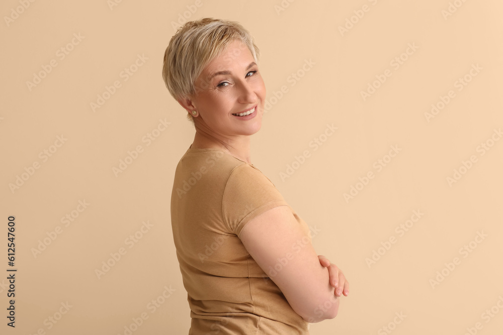 Mature blonde woman on beige background