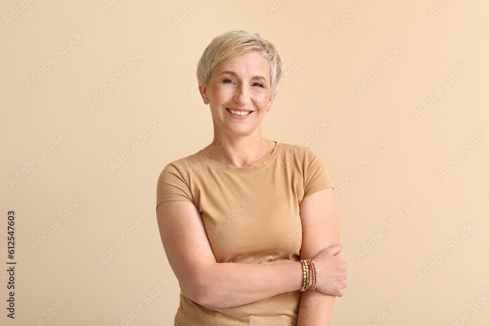 Mature blonde woman on beige background