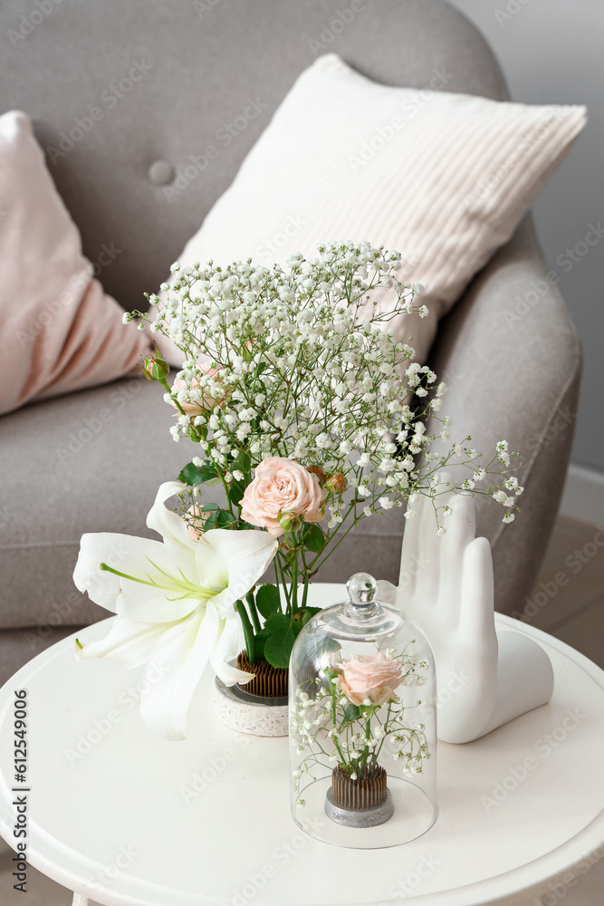 Beautiful ikebana on table in living room