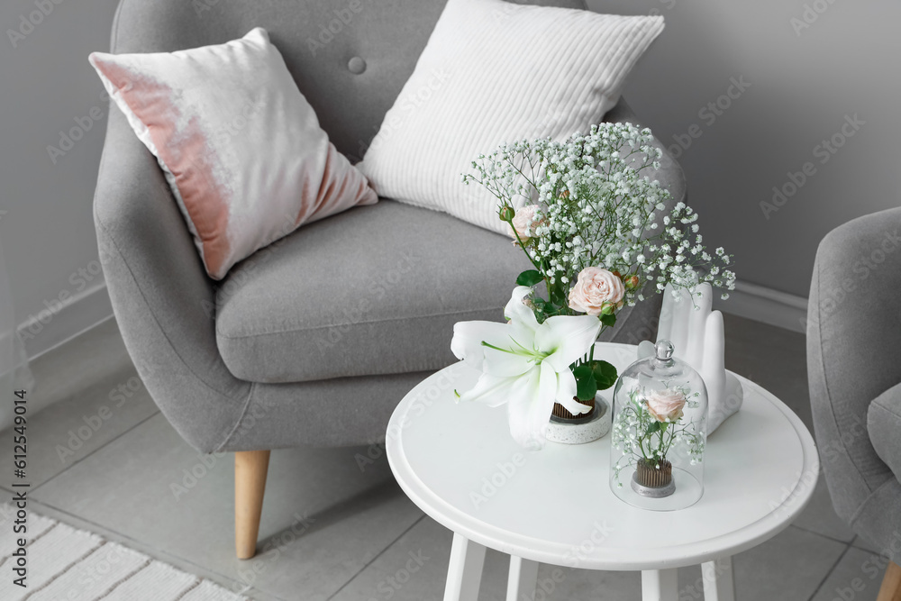 Beautiful ikebana on table in living room