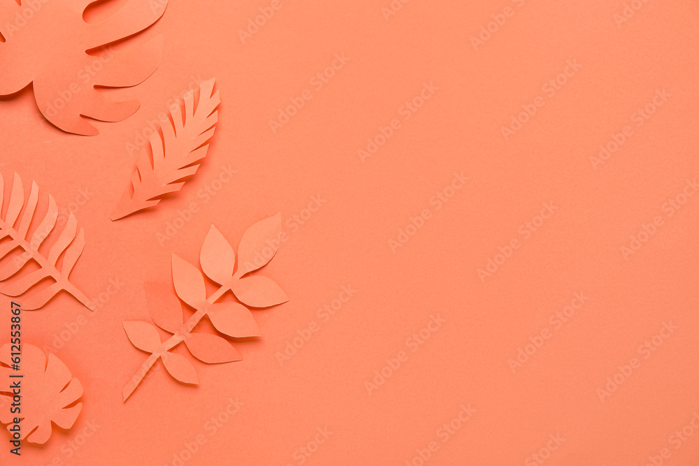 Beautiful origami leaves on orange background