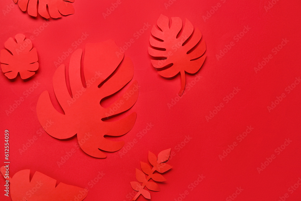 Beautiful origami leaves on red background