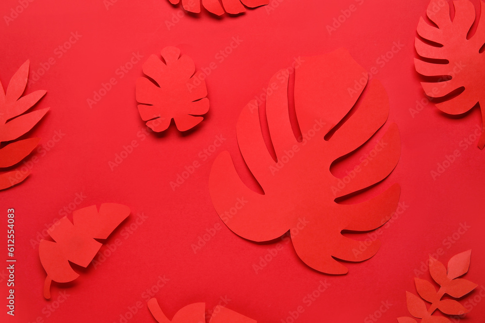 Beautiful origami leaves on red background