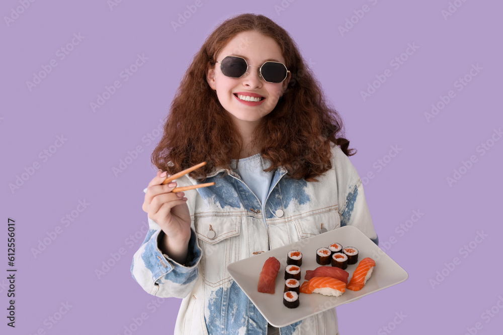 Young woman with sushi and chopsticks on lilac background