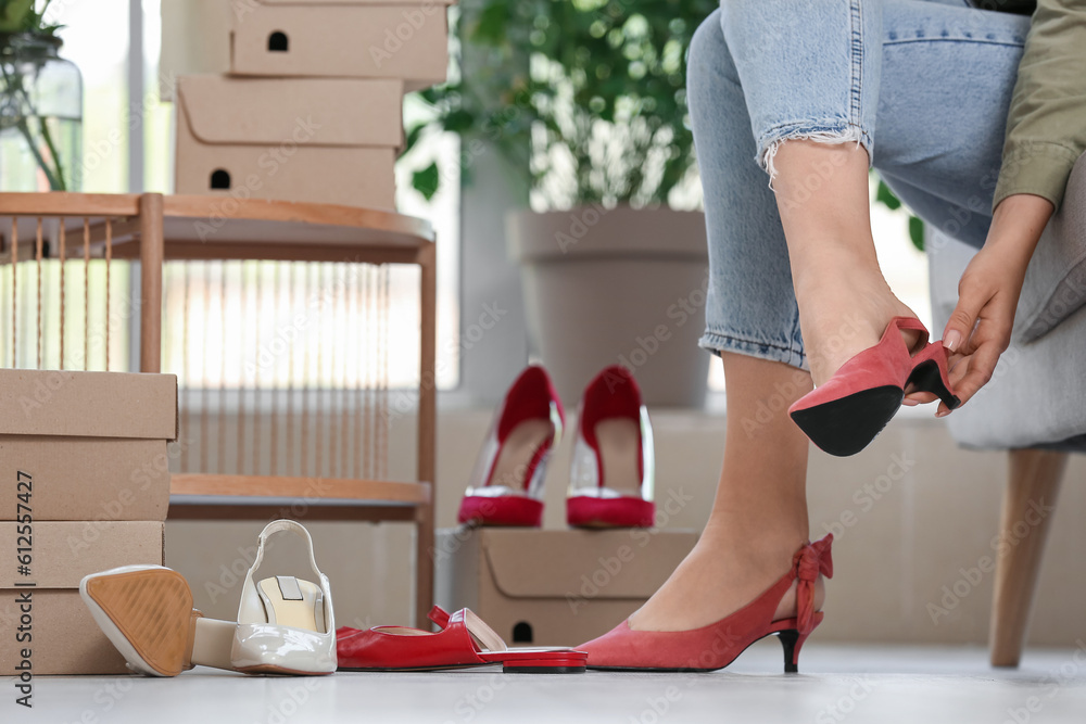 Woman trying on red shoes in boutique, closeup