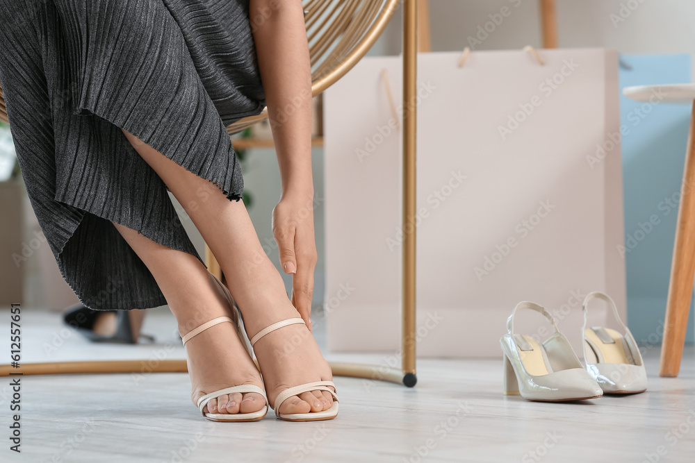 Woman trying on new shoes in boutique, closeup