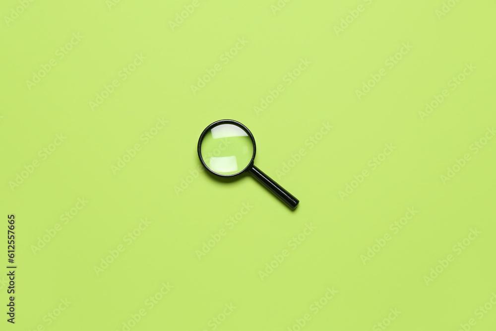 Black mini magnifier on green background