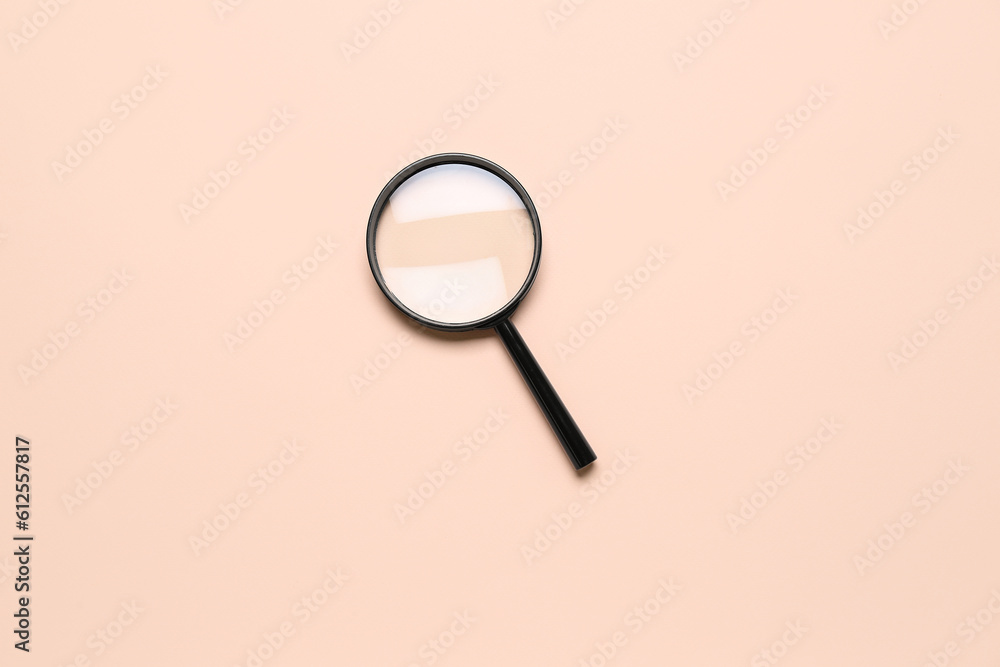 Black magnifier on pale pink background