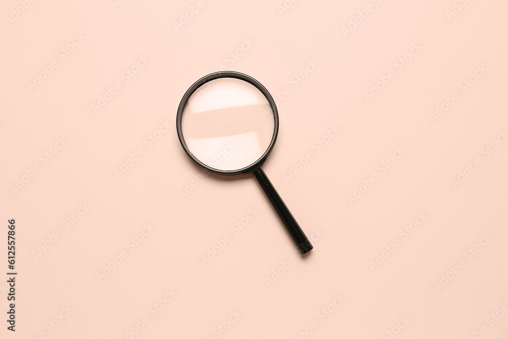 Black magnifier on pale pink background