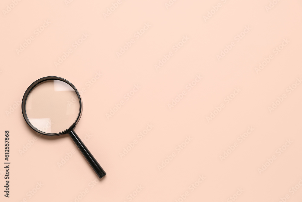 Black magnifier on pale pink background