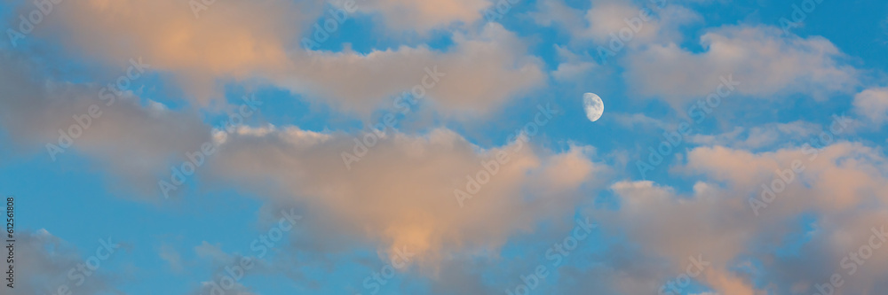 Beautiful sunset sky background with clouds. Scenic cloudscape. Wide panoramic background for design