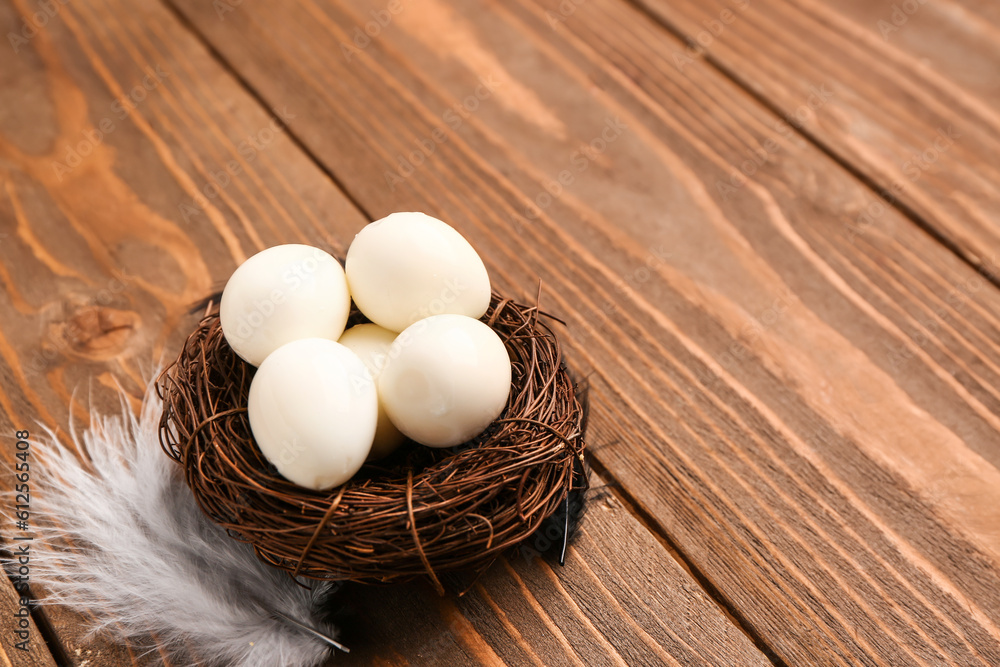 Nest of boiled quail eggs on wooden background