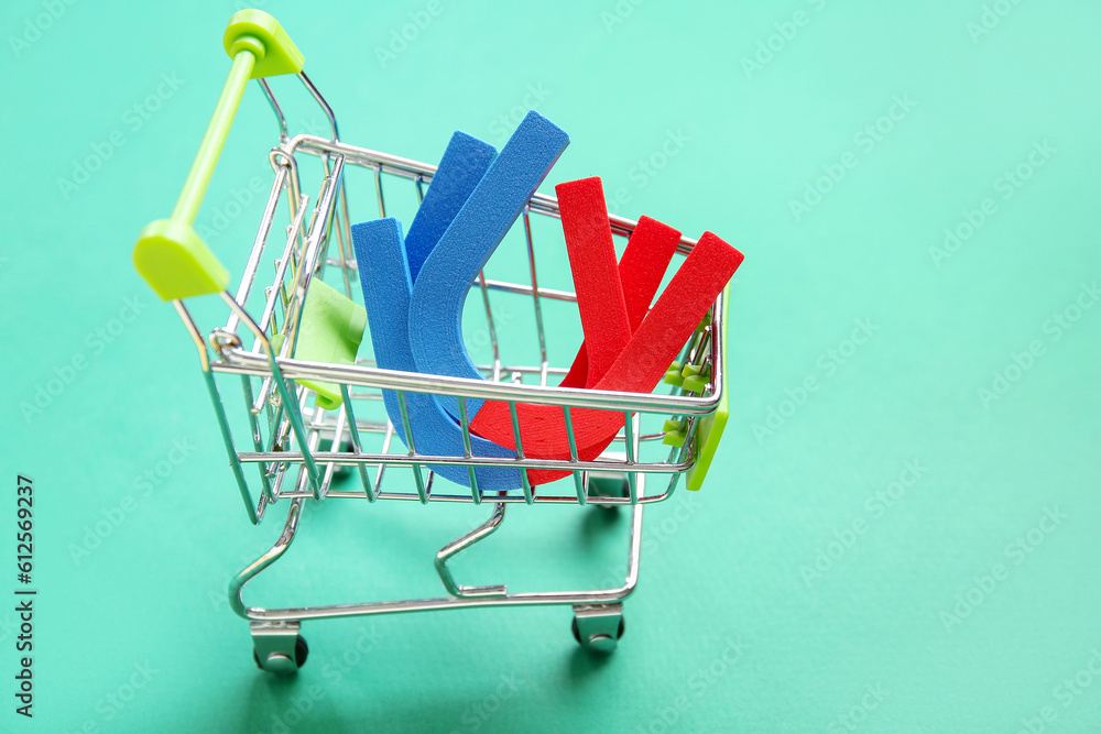 Mini trolley with magnets on green background