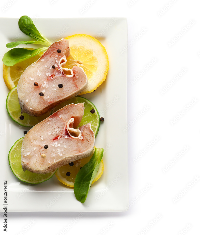 Plate with pieces of raw codfish on white background