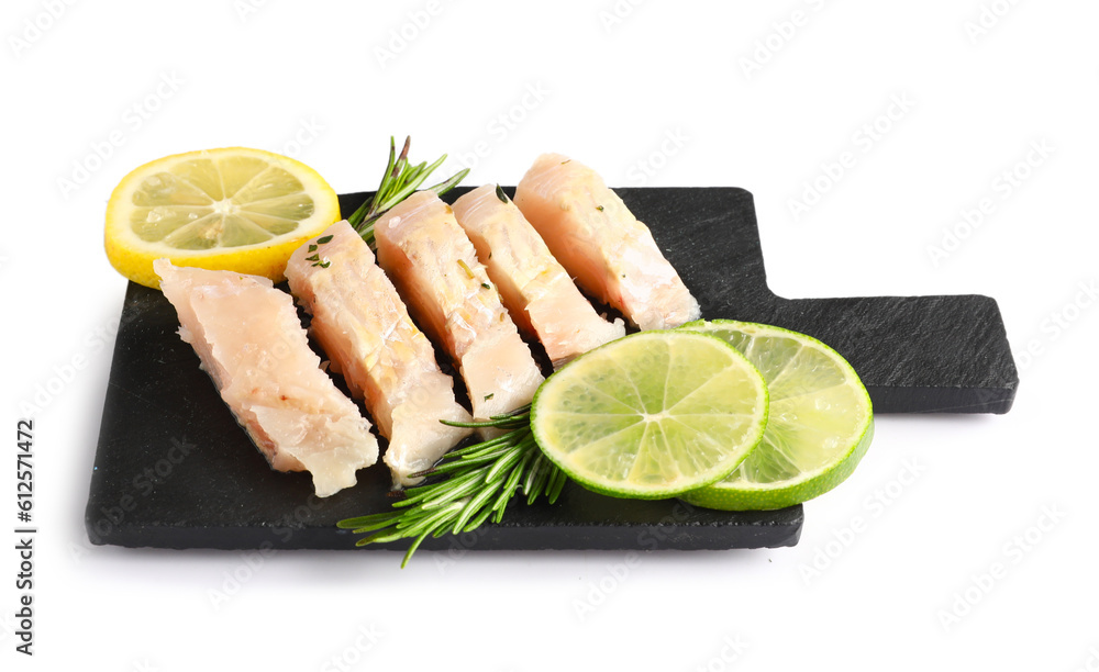 Slate board with pieces of codfish fillet on white background