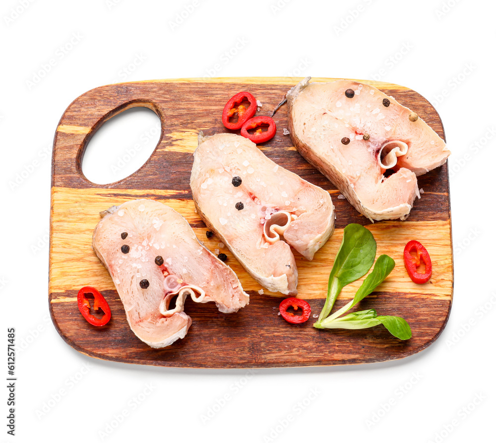 Wooden board with raw cut codfish on white background