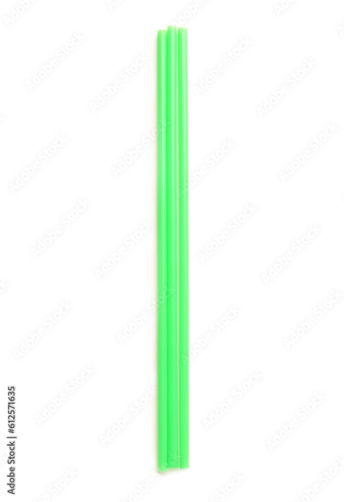 Green plastic straws on white background