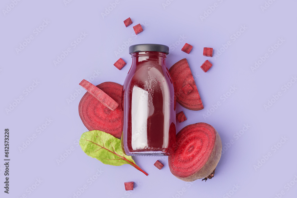 Bottle of healthy beet juice and spinach on lilac background