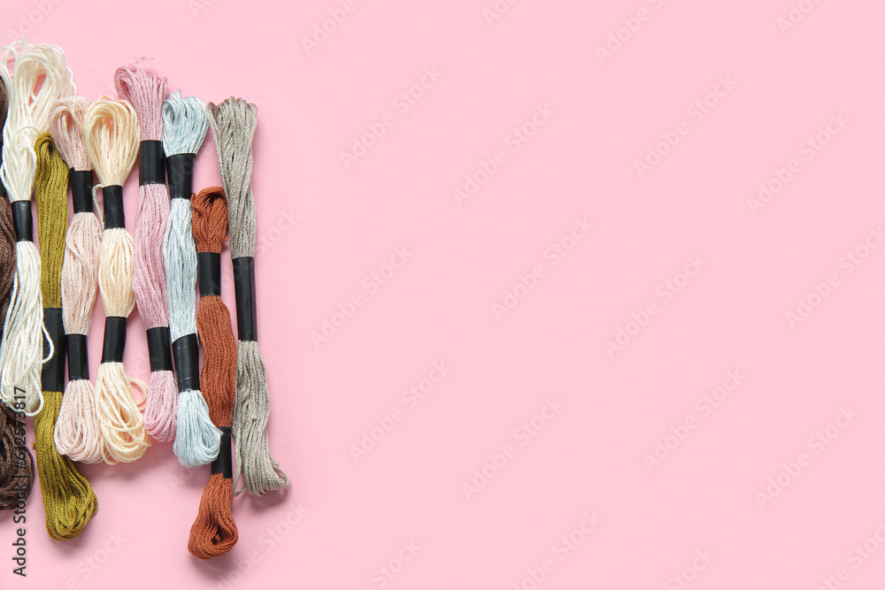 Different colorful mouline threads on pink background