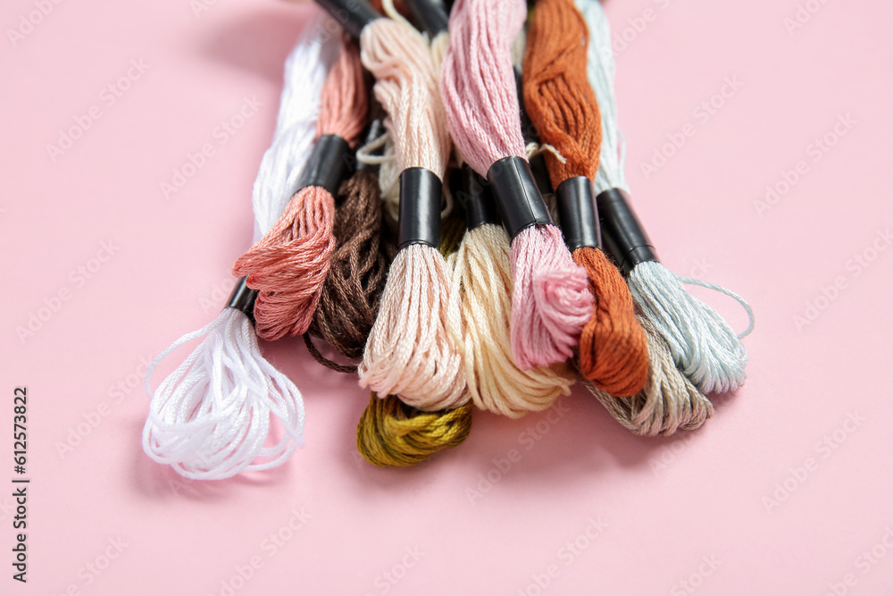 Different colorful mouline threads on pink background