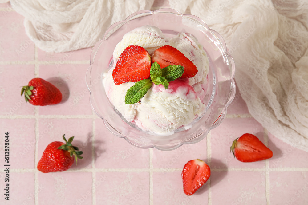 Bowl of vanilla ice cream with strawberries, mint and tablecloth on pink tile table