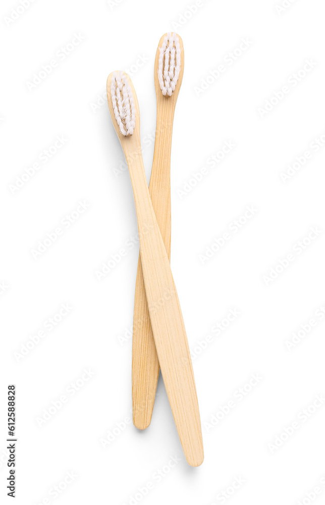 Bamboo toothbrushes on white background