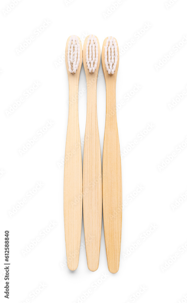 Bamboo toothbrushes on white background