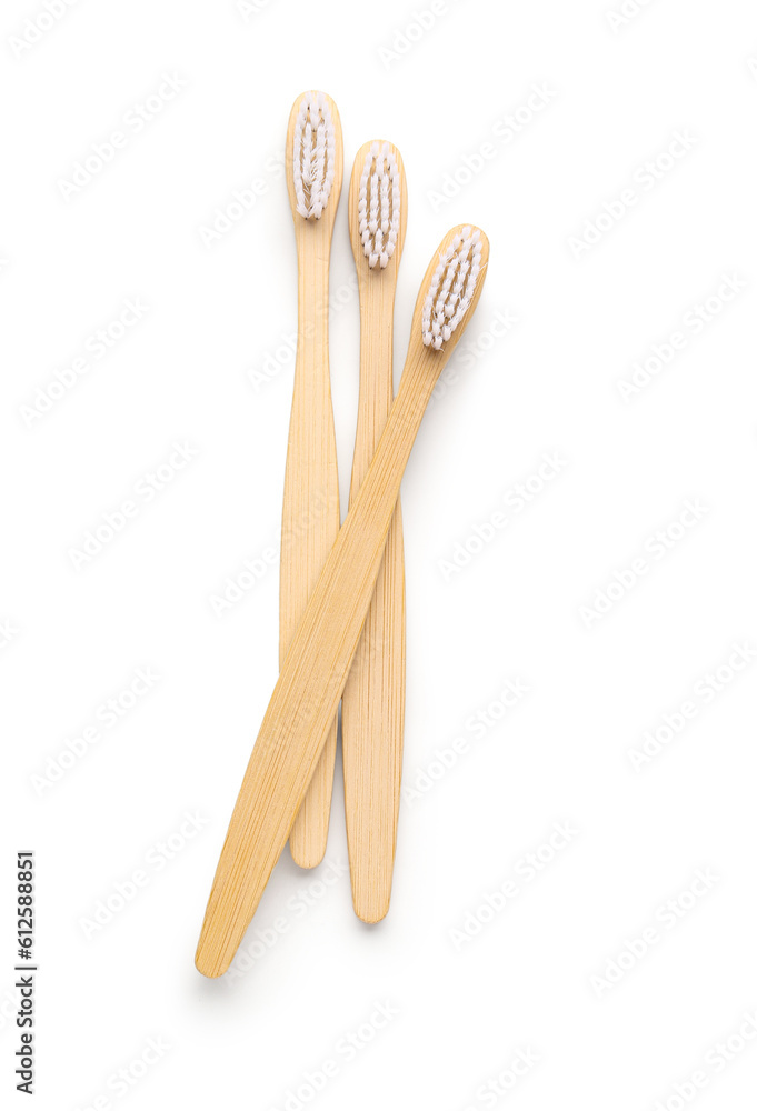 Bamboo toothbrushes on white background