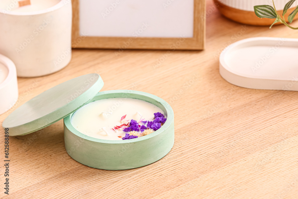 Holder with candle and decor on wooden background, closeup