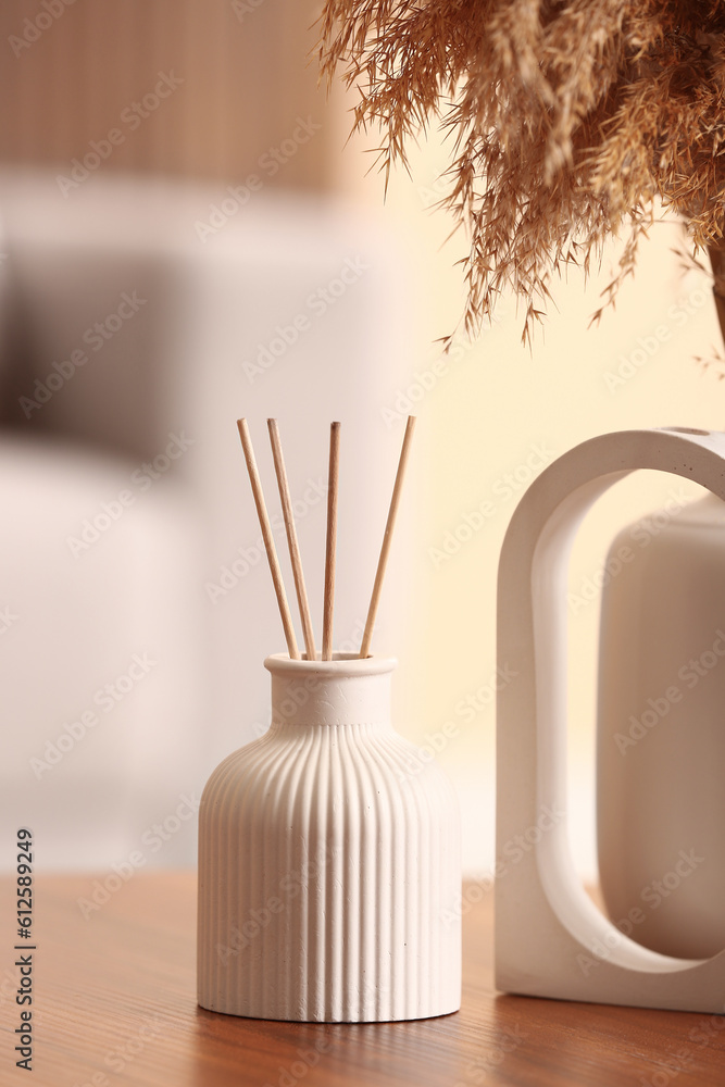 Bottle of reed diffuser on table in room, closeup