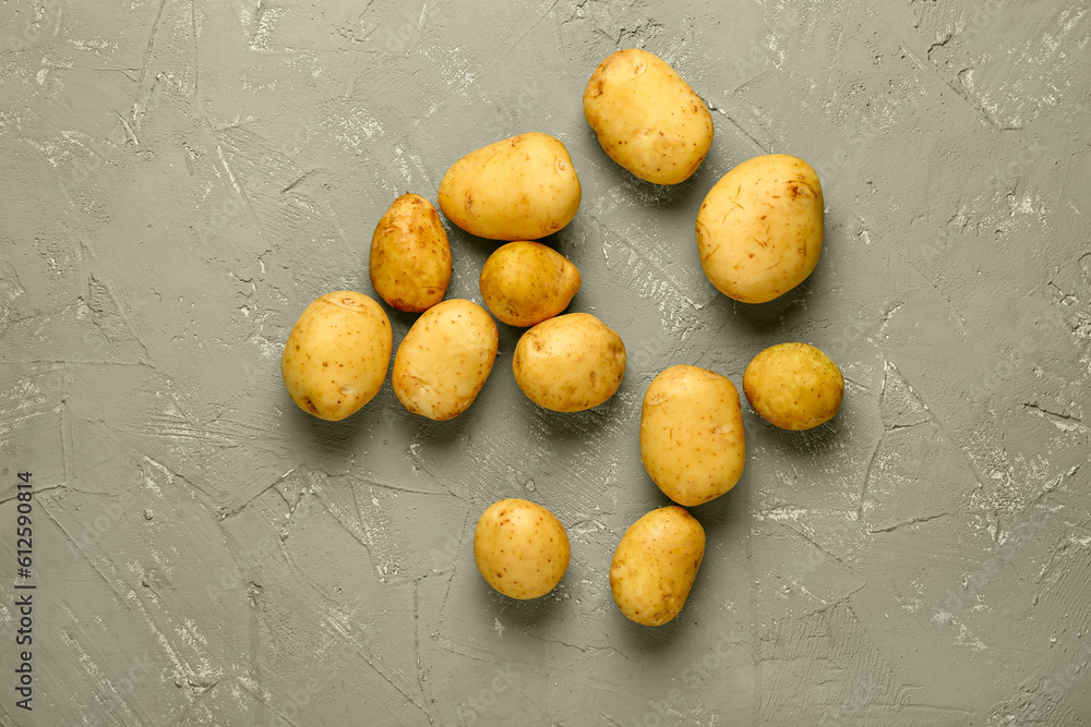 Raw baby potatoes on grey background