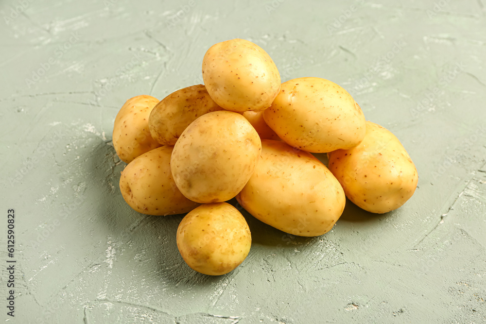 Heap of raw baby potatoes on grey background