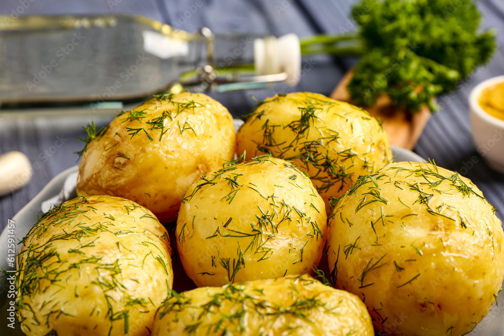 Plate of boiled baby potatoes with dill and parsley, closeup