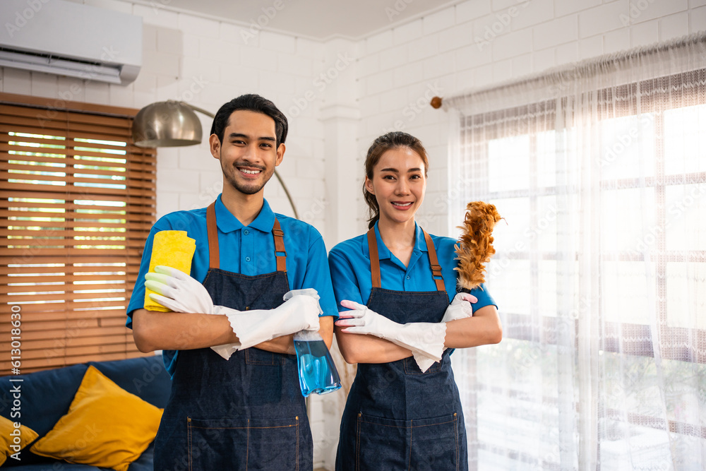 Portrait of young man and woman cleaning service worker work in house. 