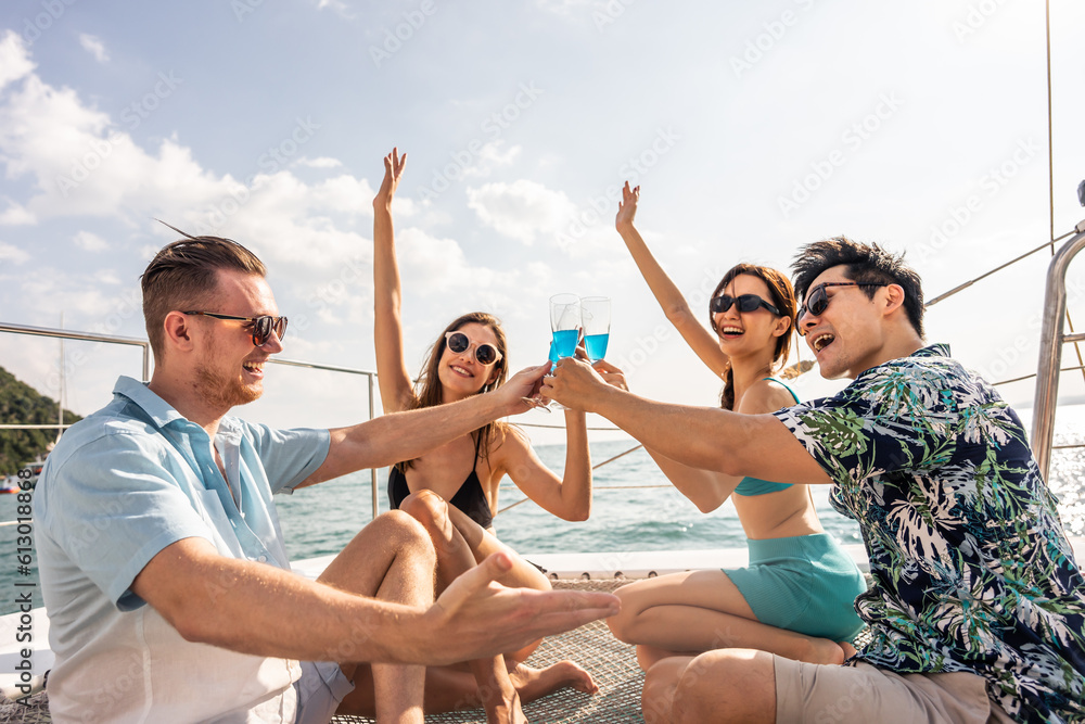 Group of diverse friends drink champagne while having a party in yacht. 