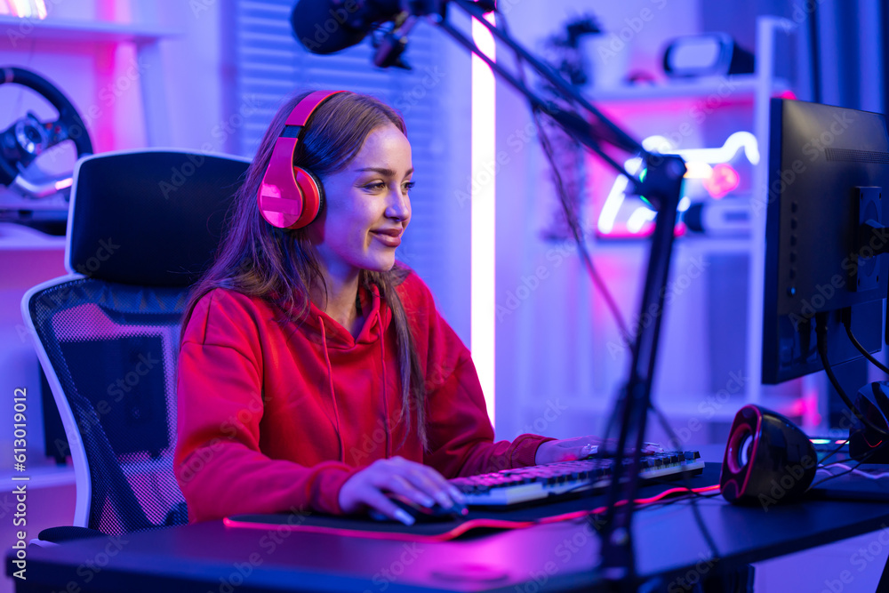 Caucasian e-sport woman gamer playing online video game on computer. 