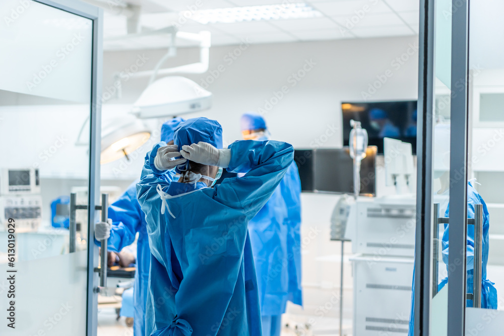 Professional doctors performing surgical operation in operating room. 