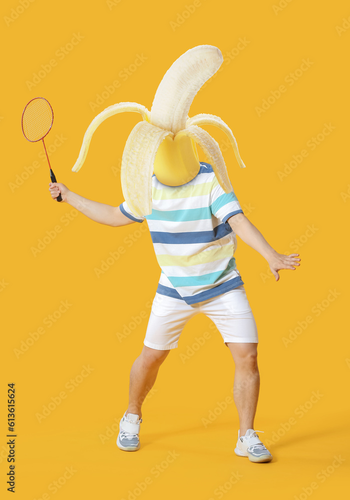 Sporty male badminton player on color background