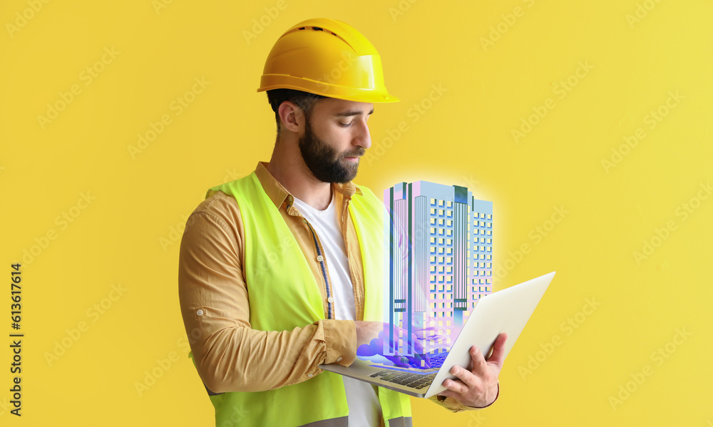 Male construction worker with laptop and new digital project of modern residential building on yello