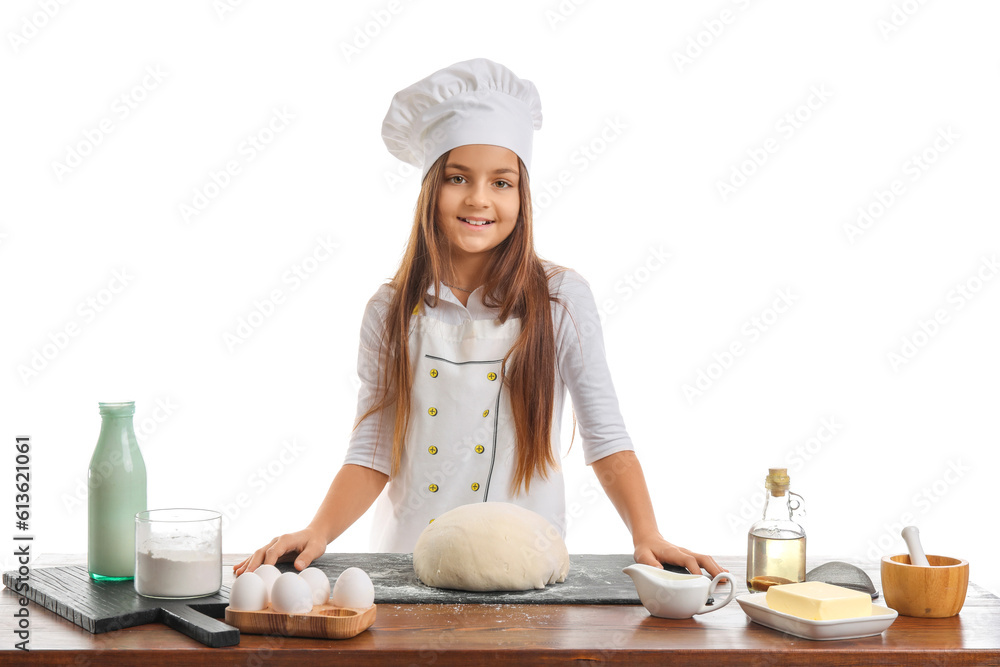 Little baker at table with dough on white background